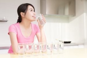 woman drink water with health concept in the kitchen