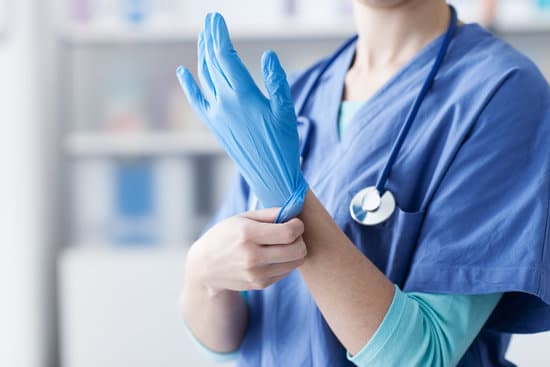 Female doctor wearing protective gloves, hands close up
