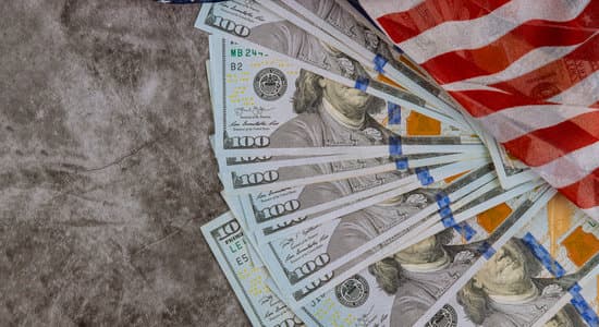 USA economic top view american flag on US dollars background