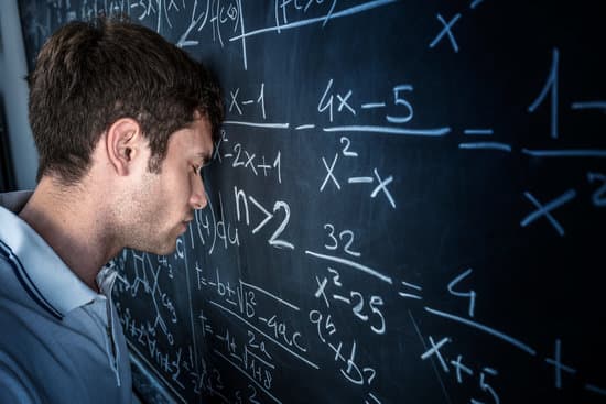 stressed student pose his head on chalkboard