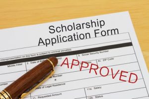 Applying for a Scholarship Approved, Scholarship Application Form with Pen on a desk