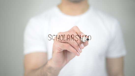 Scholarship, man writing on transparent screen