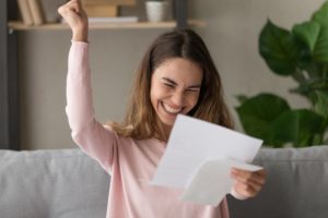 Woman pumping her first after reading her acceptance letter