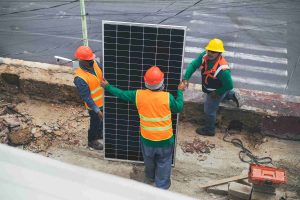 Solar technicians installing a panel on the roadside