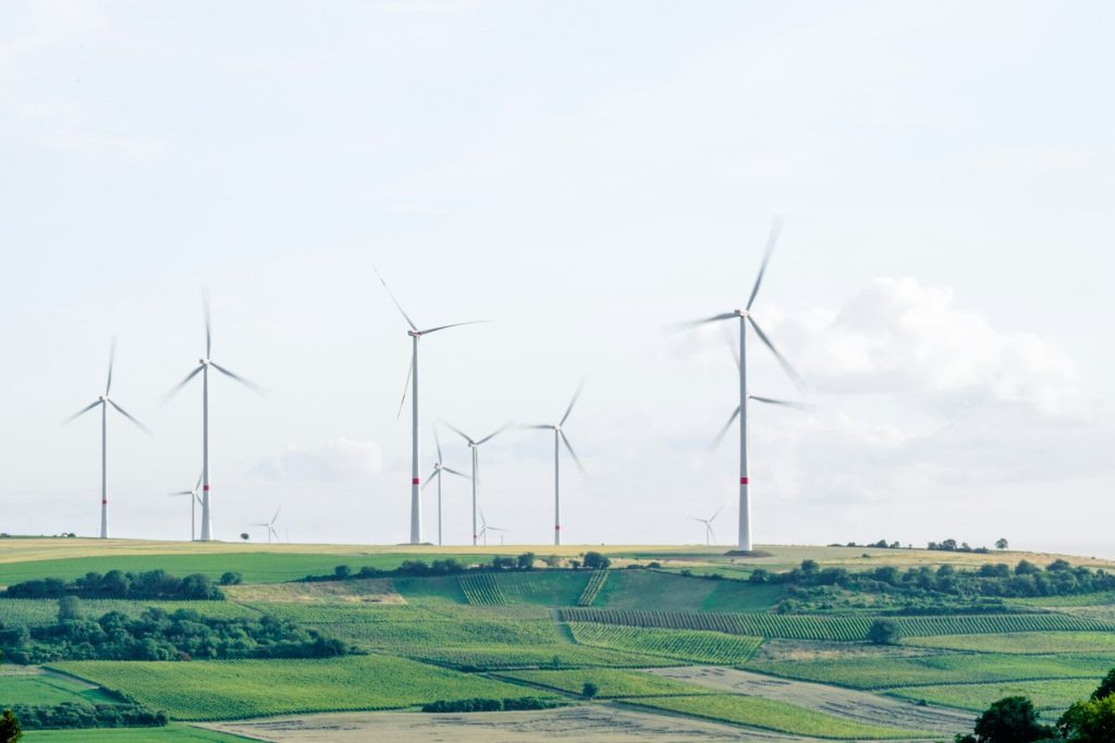 A cluster of wind turbines standing tall on a hill