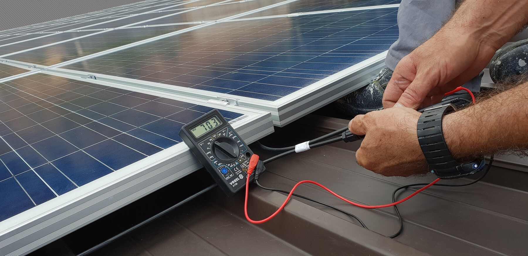 Technician checking the power supply and quality of one of the solar panels