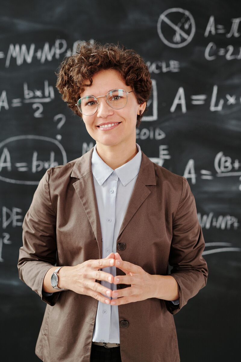 A science teacher in front of the board