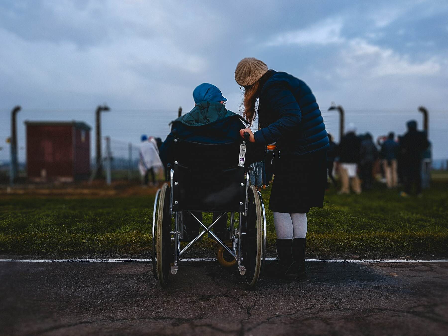 A woman assisting someone in a wheelchair