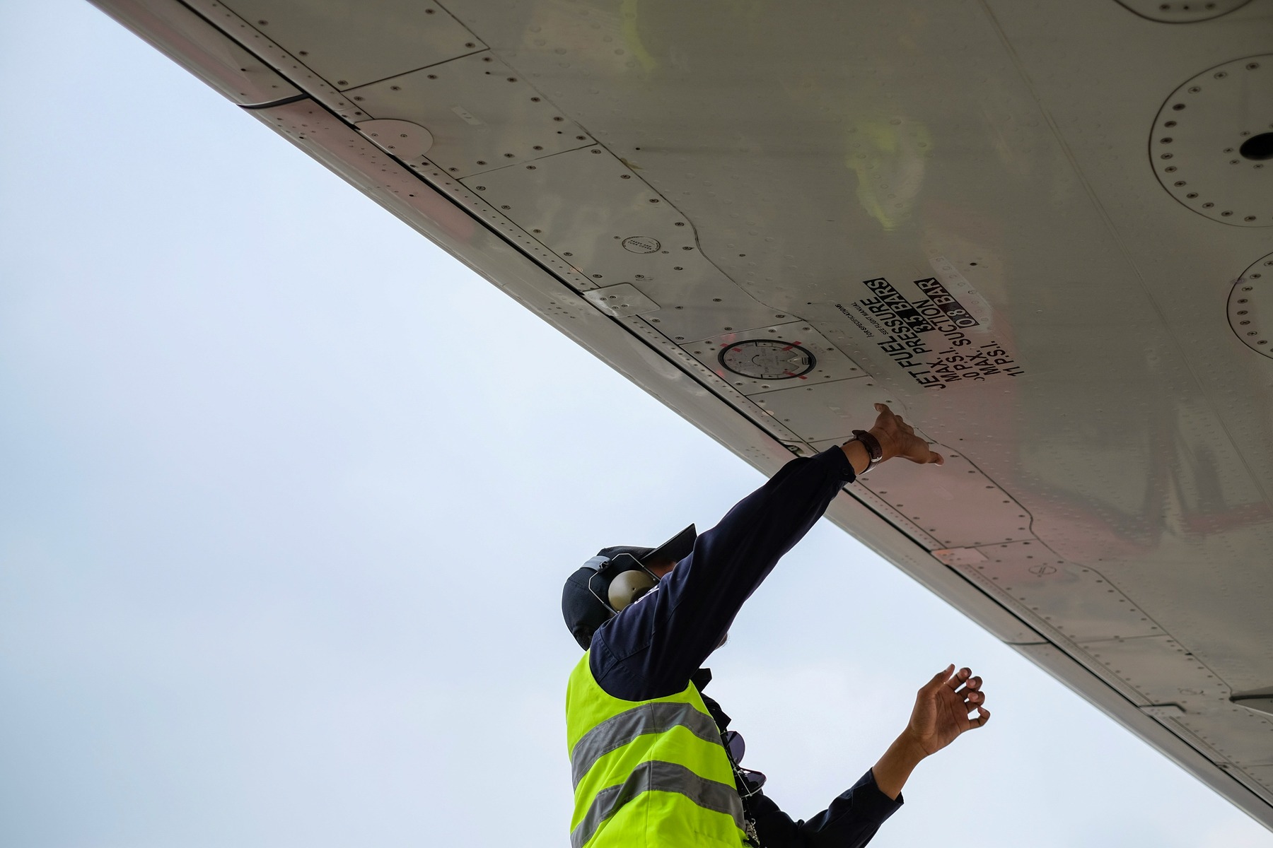 Man checking the surface of an airplane