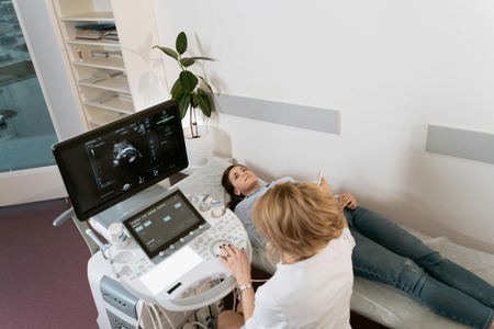 Woman performing a sonogram for a patient